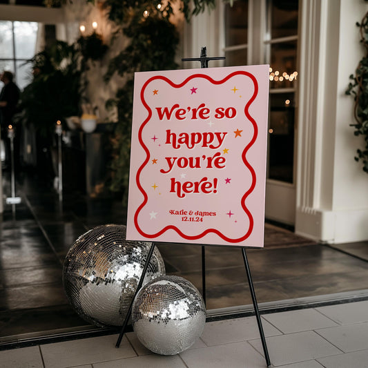 We're So Happy You're Here Pink Retro Welcome Sign