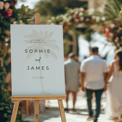 A tropical wedding welcome sign with a golden palm tree