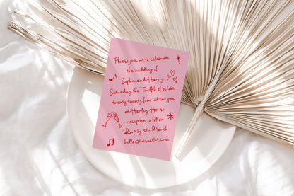 Wedding invite with a pink background and red handwritten font featuring cute doodles